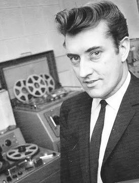 Joe Meek beside reel-to-reel recording equipment
